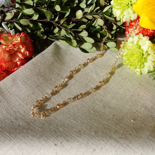 14k gold filled citrine necklace on linen cloth with flowers